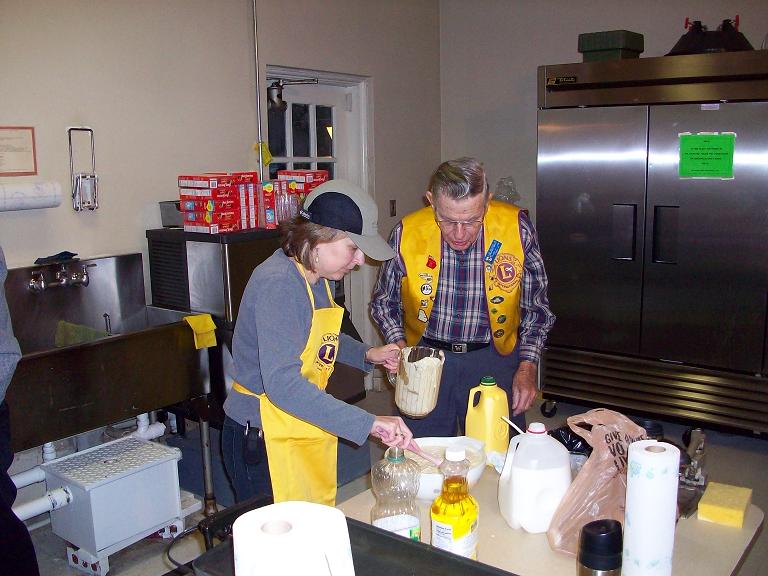 Denise Pesti mixing cakes - J B Weaver supervising.